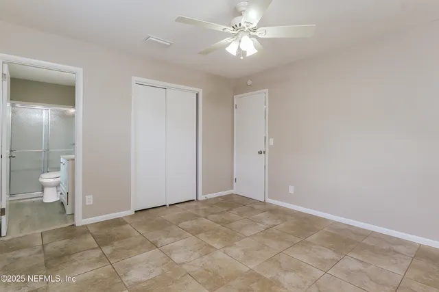 a view of an empty room and a bathroom