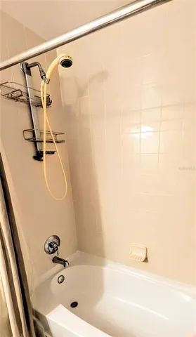 a bathroom with a shower and a bath tub