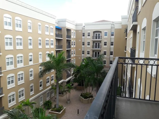 a view of a backyard with plants and outdoor seating