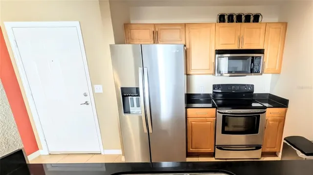a kitchen with a refrigerator stove and microwave