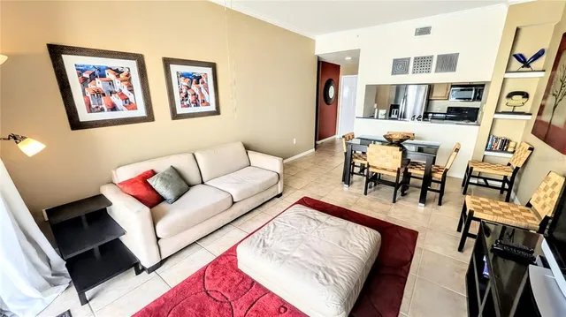 a living room with furniture and painting on the wall