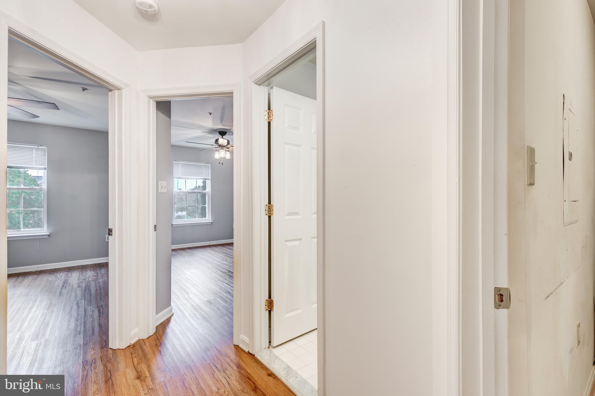 313-3 Sirens Court Odenton, MD 21113 - Photo 11 of 30 a view of a hallway with wooden floor