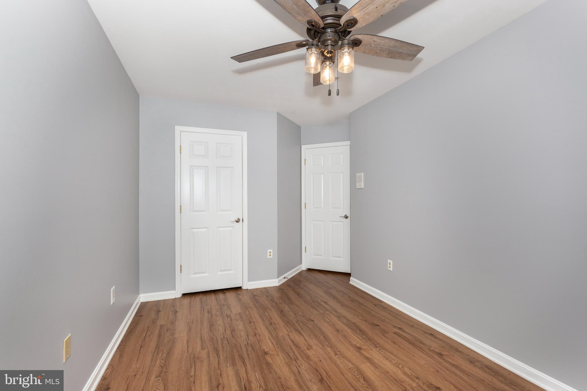 313-3 Sirens Court Odenton, MD 21113 - Photo 14 of 30 a view of an empty room with wooden floor