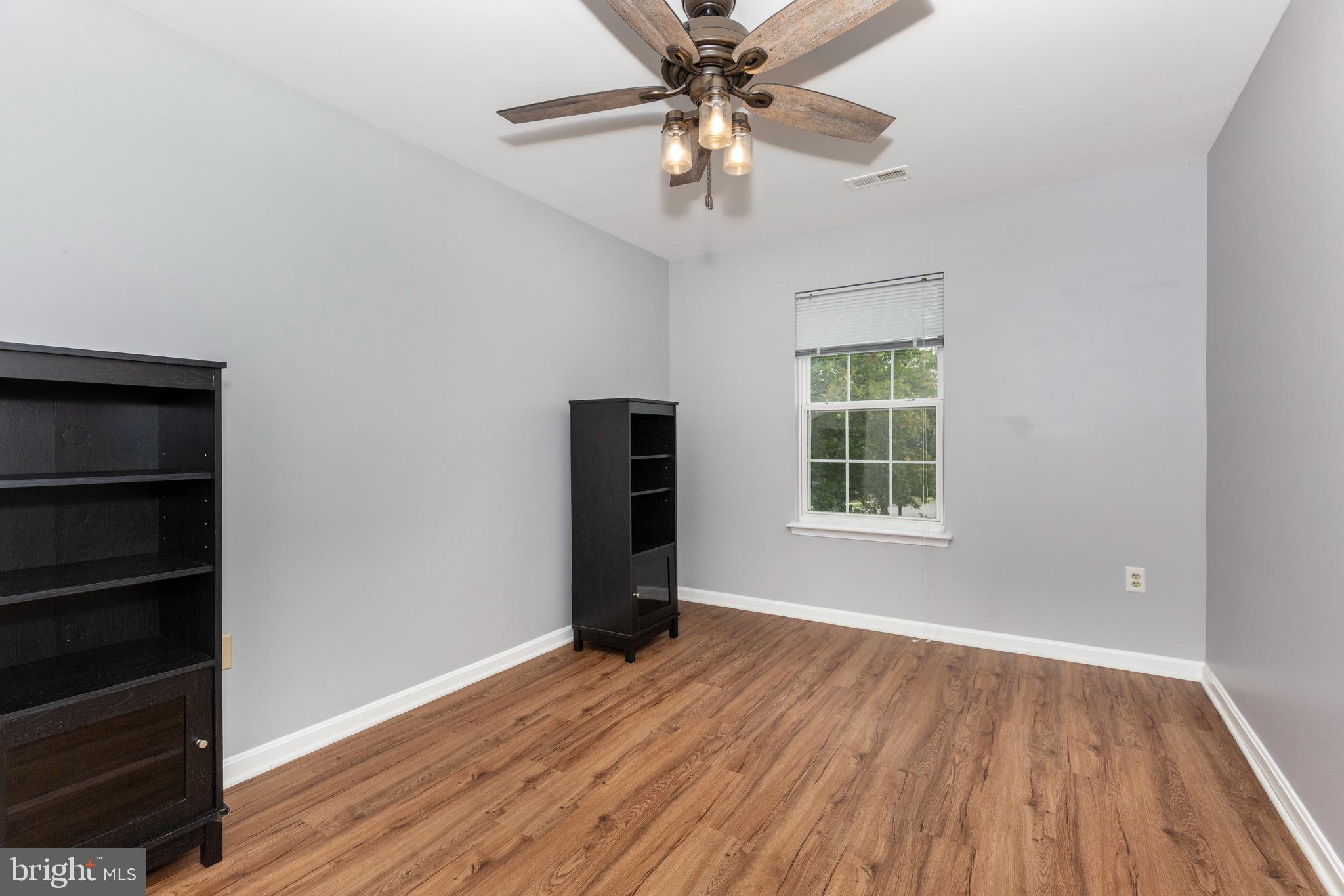 313-3 Sirens Court Odenton, MD 21113 - Photo 15 of 30 wooden floor in an empty room with a window
