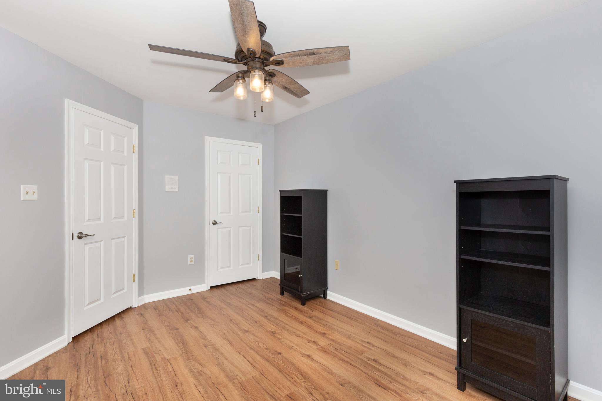 313-3 Sirens Court Odenton, MD 21113 - Photo 16 of 30 a view of an empty room with a window and wooden floor