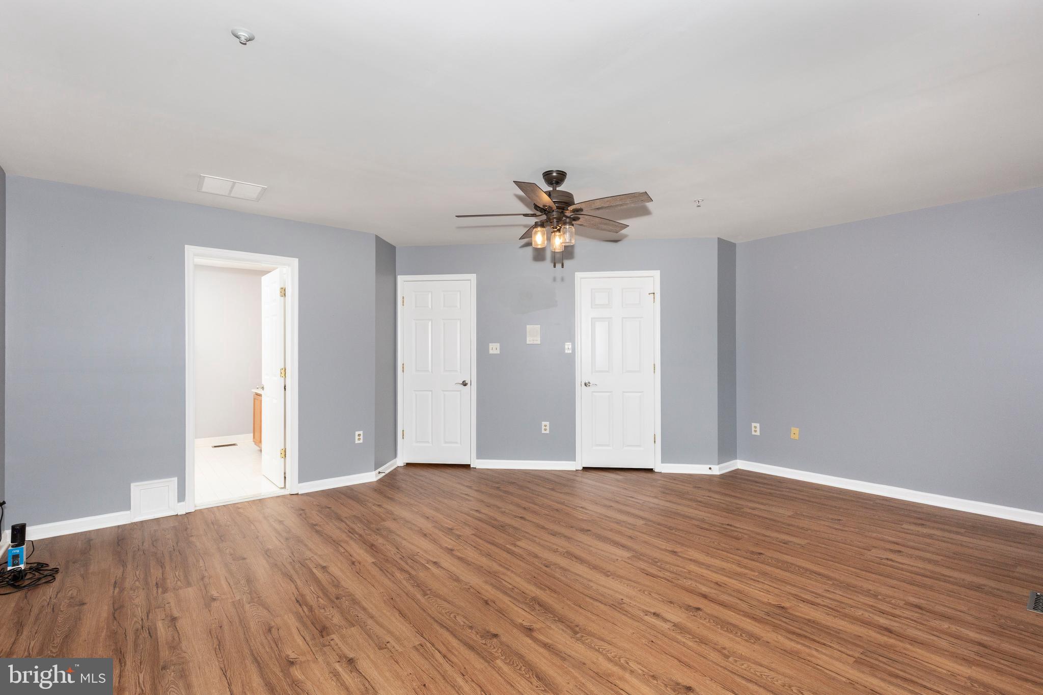 313-3 Sirens Court Odenton, MD 21113 - Photo 21 of 30 a view of an empty room with wooden floor