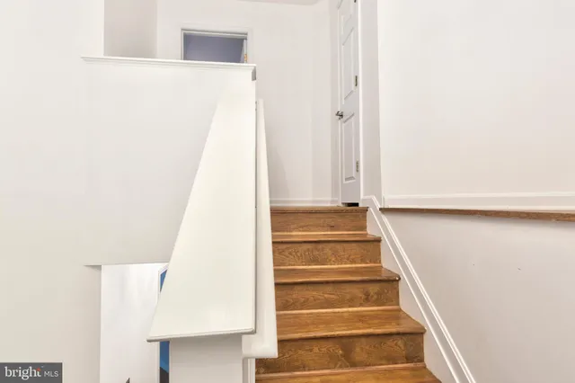 a view of staircase with white walls