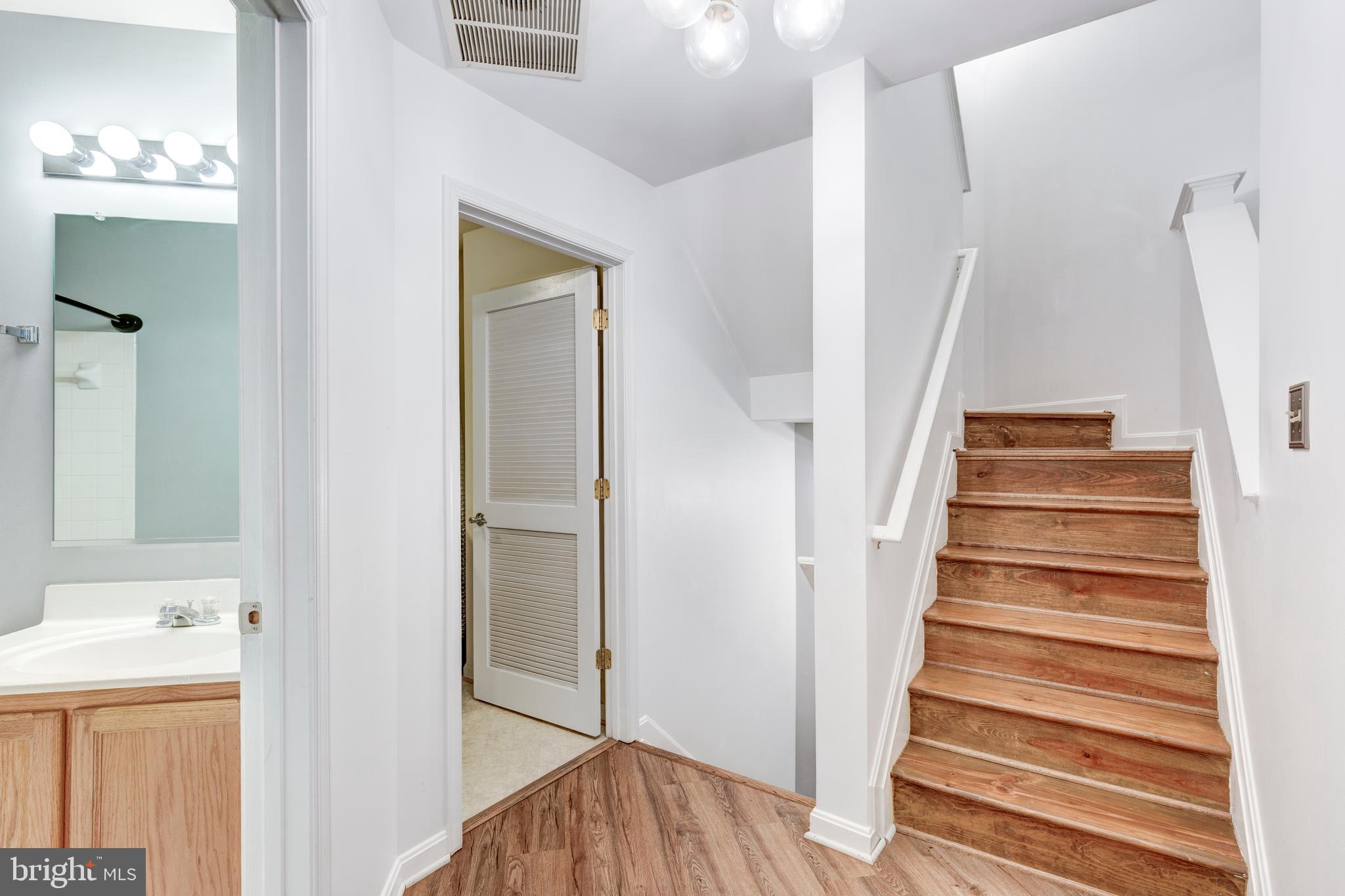 313-3 Sirens Court Odenton, MD 21113 - Photo 27 of 30 a view of a hallway with wooden floor and entryway