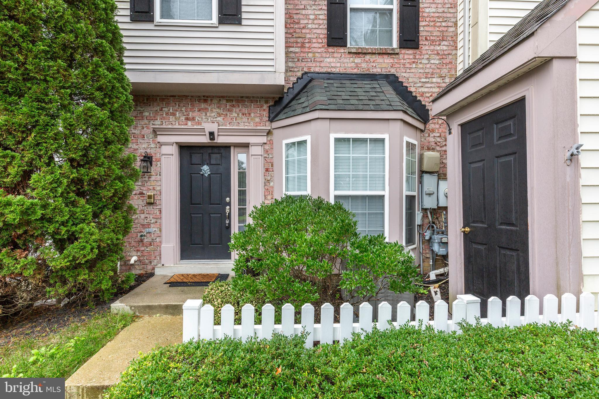 313-3 Sirens Court Odenton, MD 21113 - Photo 29 of 30 a front view of a house with a garden