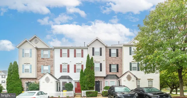 a front view of a residential apartment building with a yard