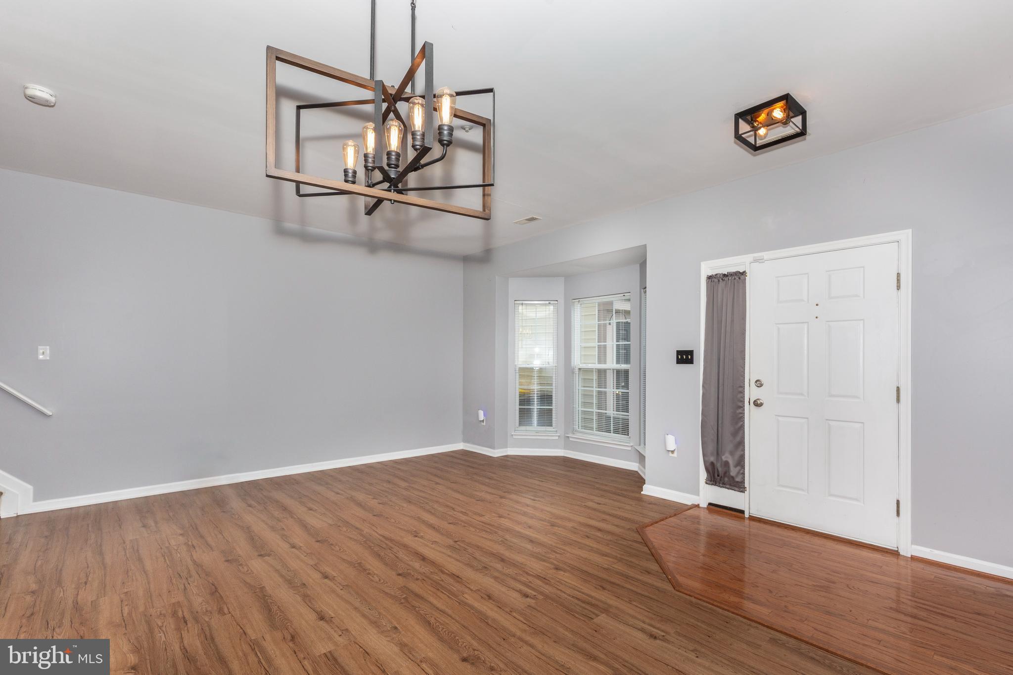 313-3 Sirens Court Odenton, MD 21113 - Photo 6 of 30 a view of a livingroom with a hardwood floor and a ceiling fan