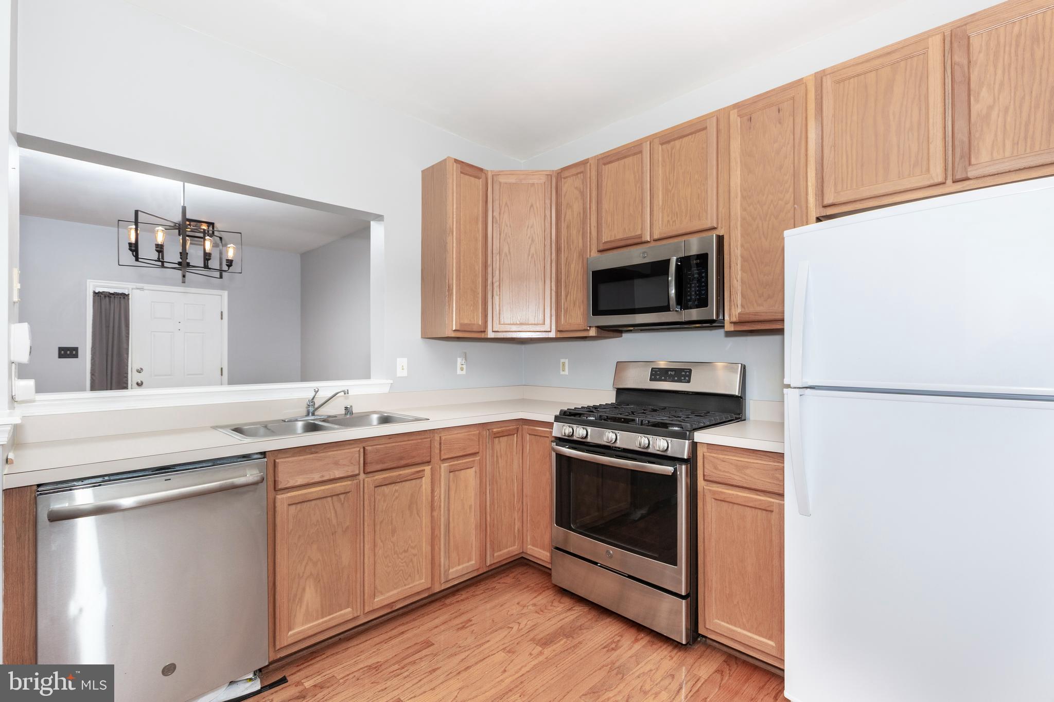 313-3 Sirens Court Odenton, MD 21113 - Photo 8 of 30 a kitchen with a sink stove and microwave