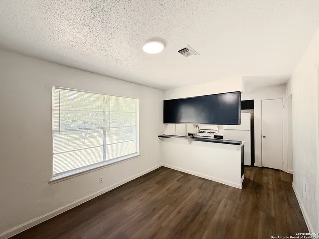 a living room with a flat screen tv and a window