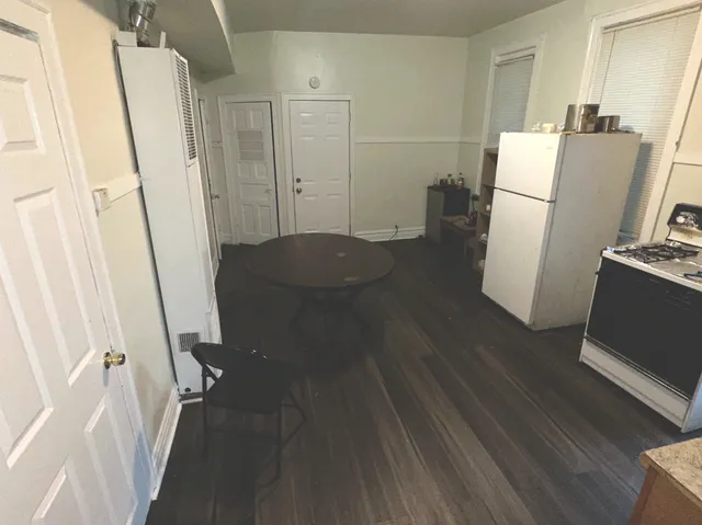 a kitchen with a refrigerator and a stove