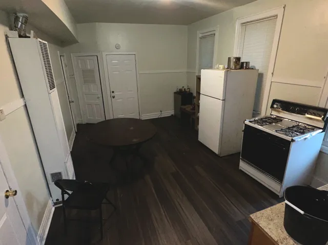a kitchen with refrigerator a washer and dryer