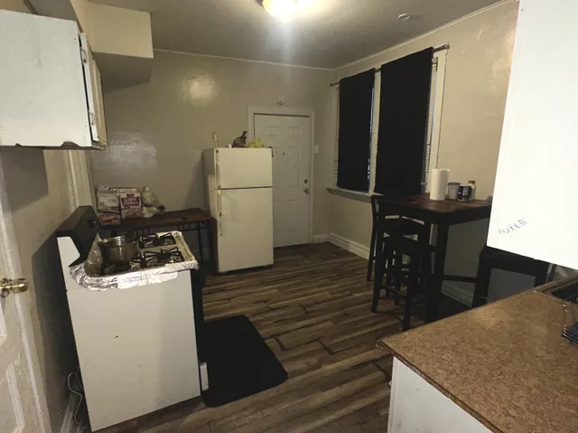 a kitchen with a refrigerator and a stove