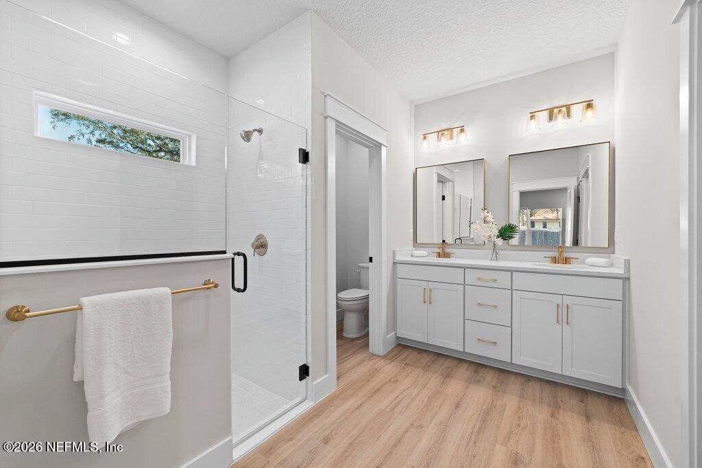 9019 Hipps Road Jacksonville, FL 32222 - Photo 32 of 35 a spacious bathroom with a granite countertop sink a mirror a shower and a bathtub