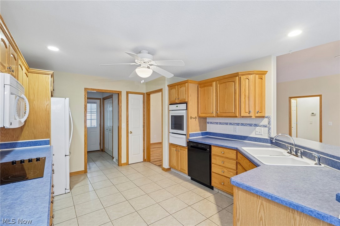 7007 Clingan Road, Unit 85 Youngstown, OH 44514 - Photo 20 of 46 Kitchen featuring light wood cabinetry, blue countertops, tile flooring, recessed lighting, and a white ceiling fan