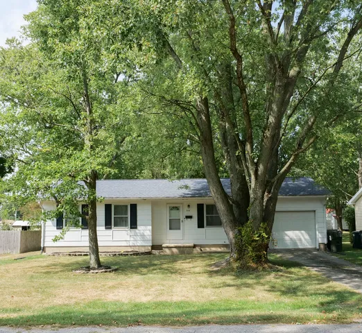 a view of a house with garden and trees