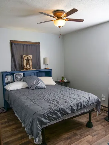 a bedroom with a bed and a chandelier