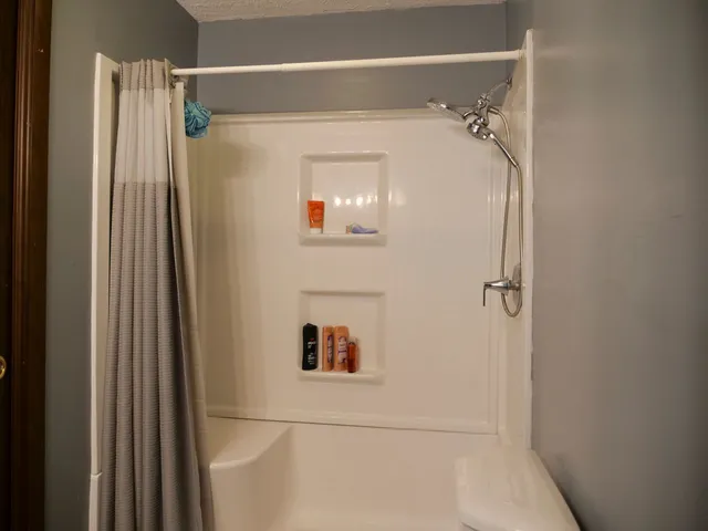 a bathroom with a shower and a shower