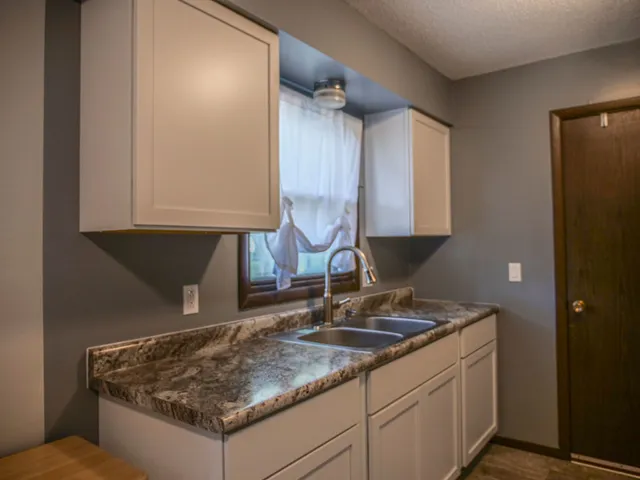 a kitchen with sink and window