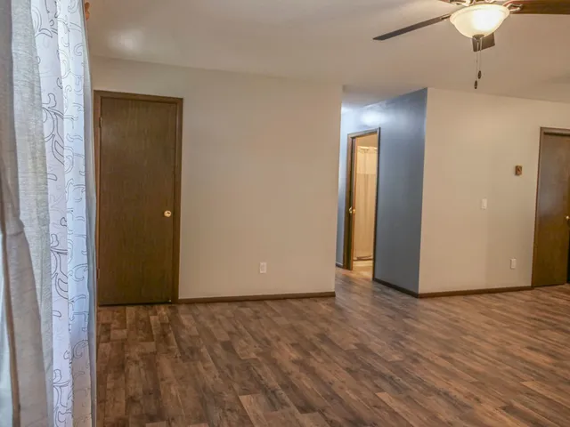 a view of an empty room with wooden floor