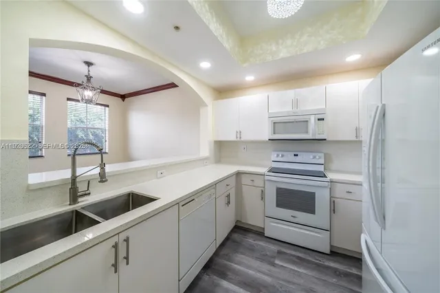 a kitchen with a sink appliances and cabinets