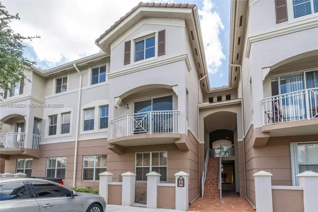 a front view of a residential apartment building with a yard