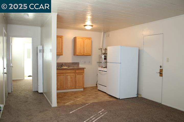 5103 Panama Avenue, Unit A Richmond, CA 94804 - Photo 3 of 10 a kitchen with a refrigerator and a stove