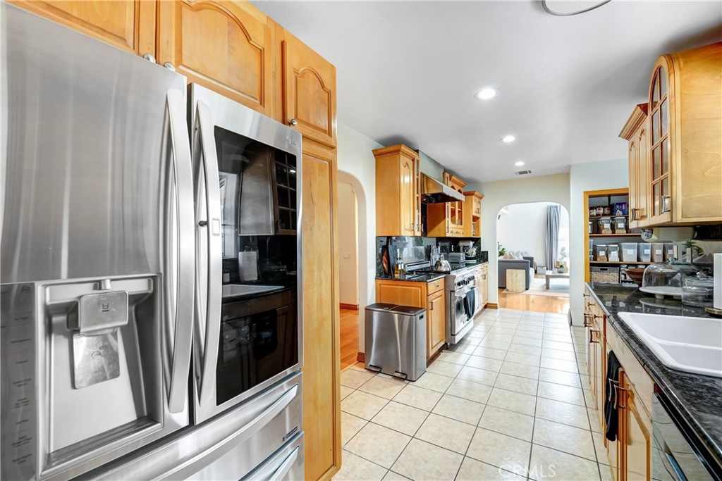 11242 Sheldon Street Sun Valley, CA 91352 - Photo 11 of 15 a large kitchen with stainless steel appliances granite countertop a refrigerator and a sink