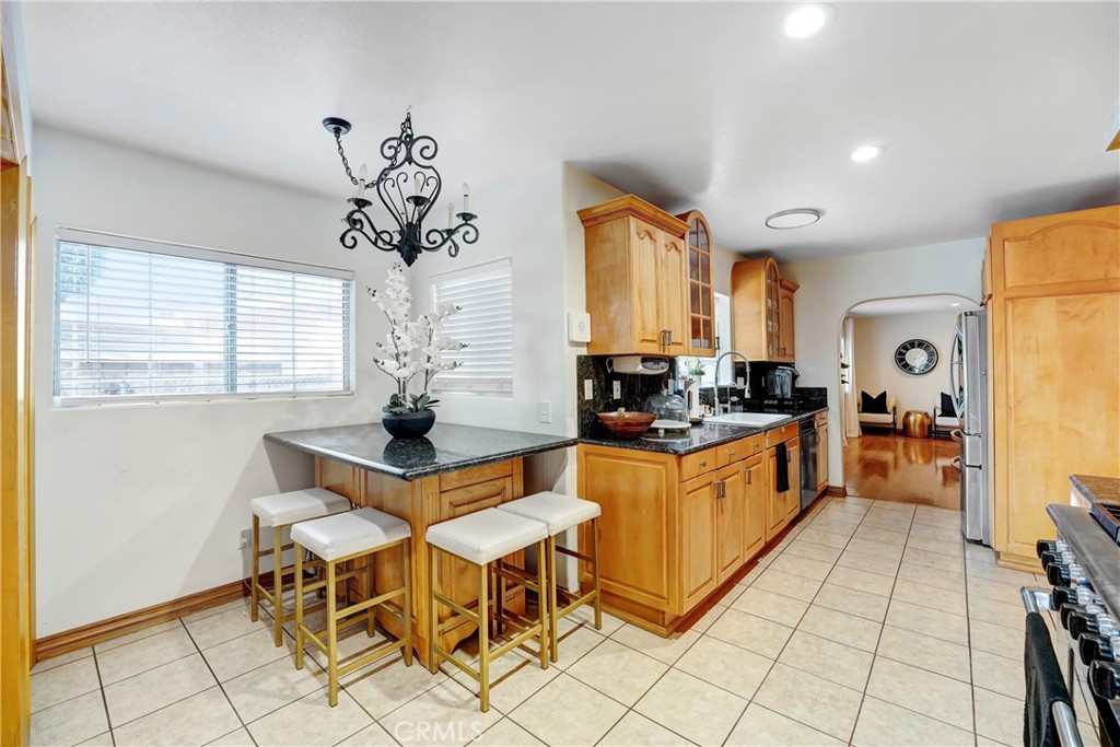 11242 Sheldon Street Sun Valley, CA 91352 - Photo 12 of 15 a kitchen with stainless steel appliances a table and chairs in it