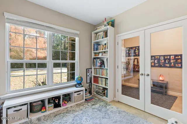 a living room with furniture and painting on the wall