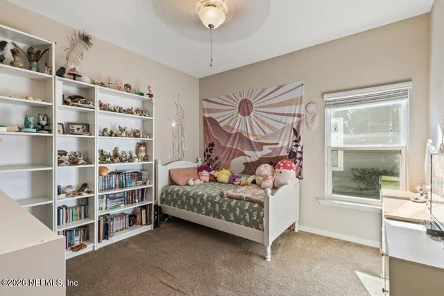 a bedroom with a bed furniture and a window