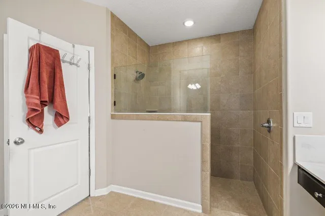 a kitchen with stainless steel appliances granite countertop a stove refrigerator a sink a microwave oven with a dining table and chairs