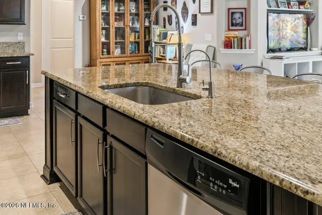 a backyard of a house with table and chairs