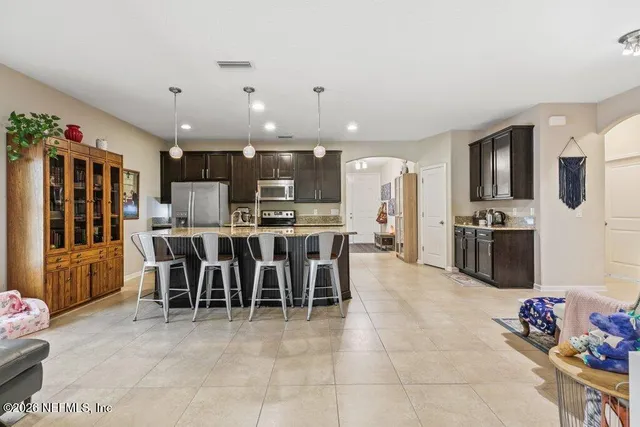 an aerial view of a house with garden space and trees all around