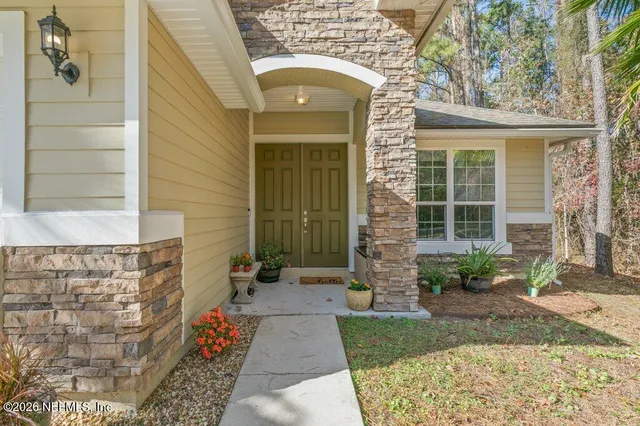a view of a refrigerator and a living room view