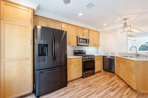 a view of a black white building with wooden floor