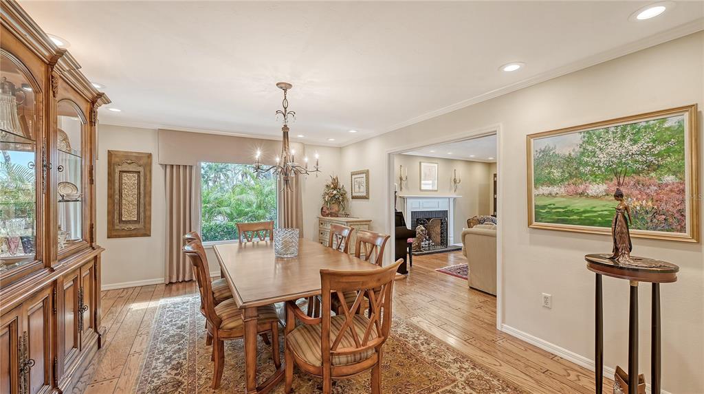 1042 North Casey Key Road Nokomis, FL 34275 - Photo 20 of 77 a view of a dining room with furniture window and wooden floor