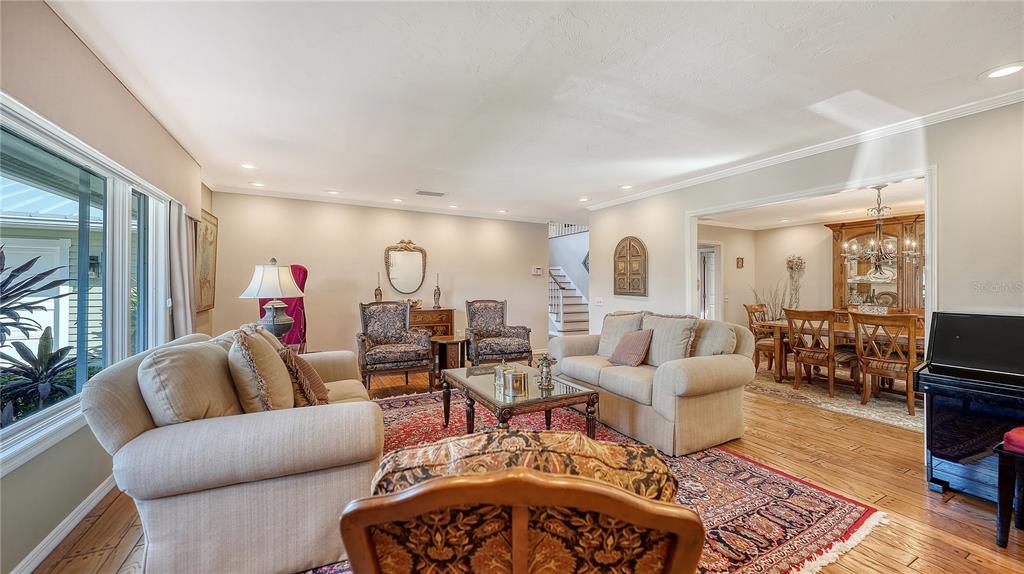 1042 North Casey Key Road Nokomis, FL 34275 - Photo 21 of 77 a living room with furniture and a flat screen tv