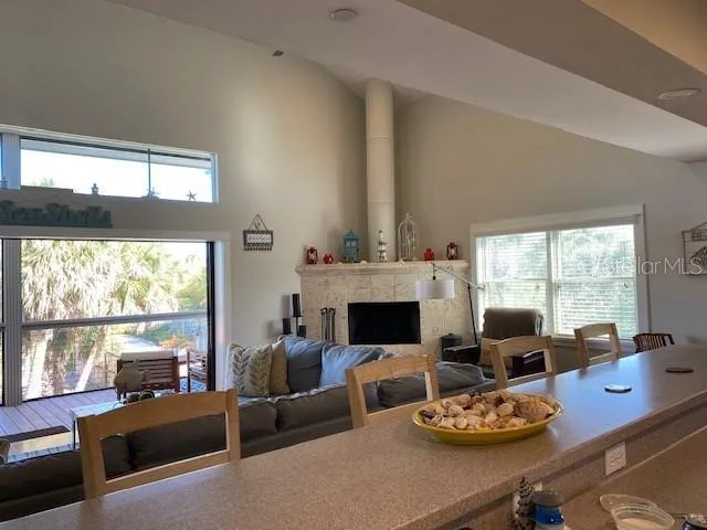 a living room with furniture fireplace and a large window