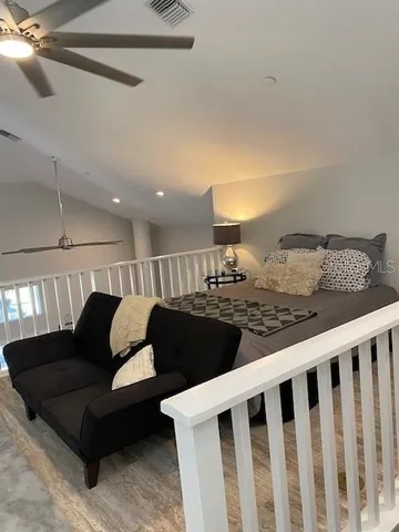 a living room with furniture lamp and wooden floor