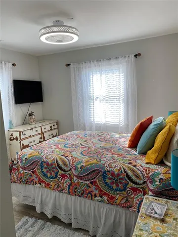 a bedroom with a bed and a television