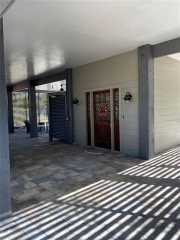 a view of an empty room with closet and mirror