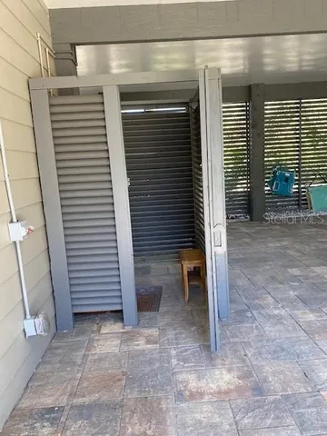 a view of a house with a patio and a yard