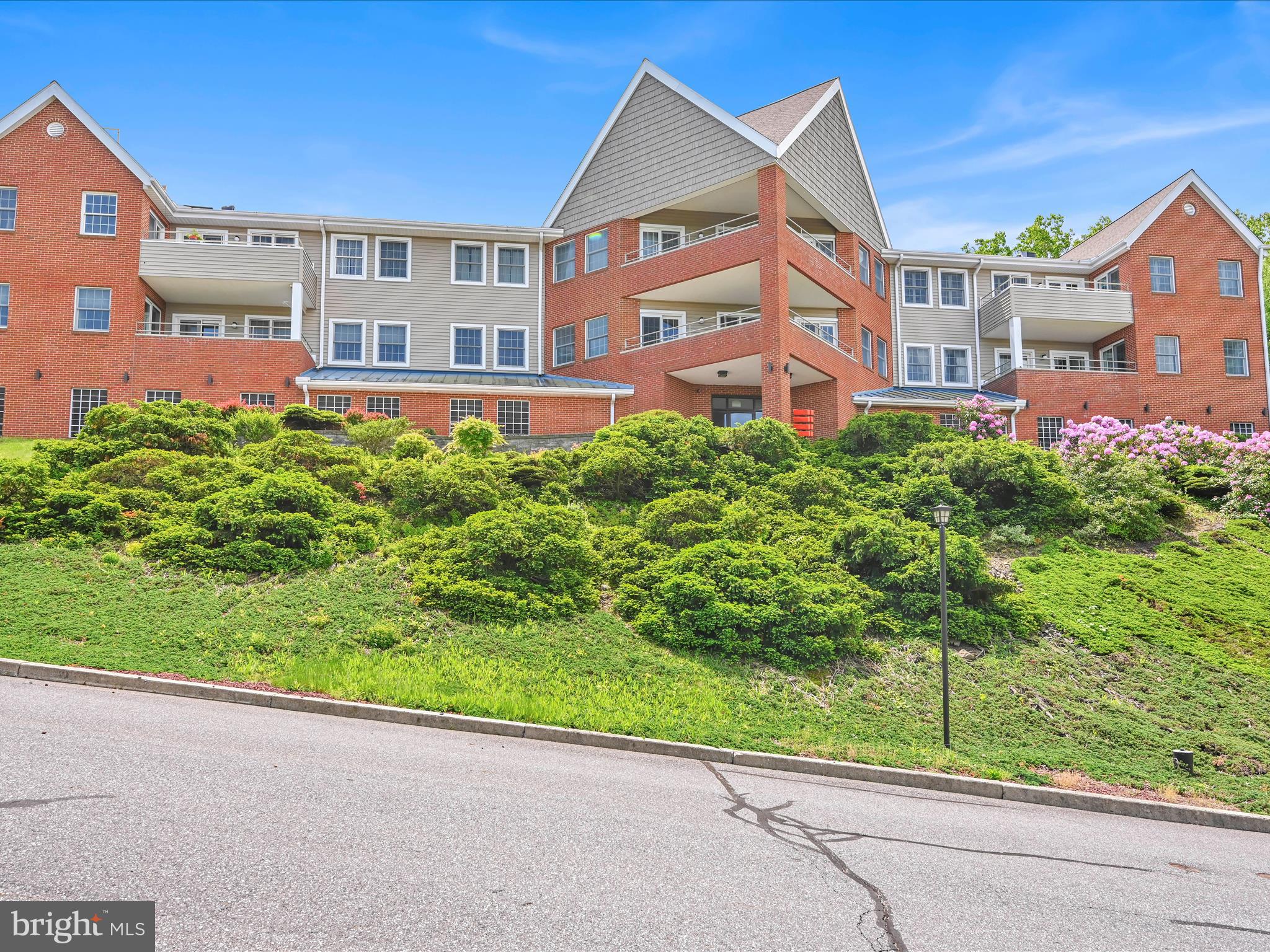 a view of a brick building next to a yard