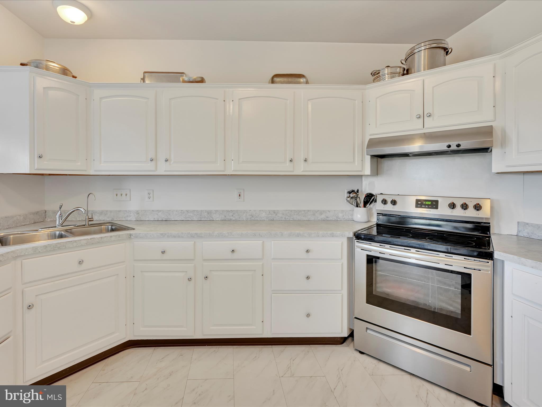 2415 Sharp Mountain Road Pottsville, PA 17901 - Photo 14 of 36 a kitchen with granite countertop white cabinets and stainless steel appliances