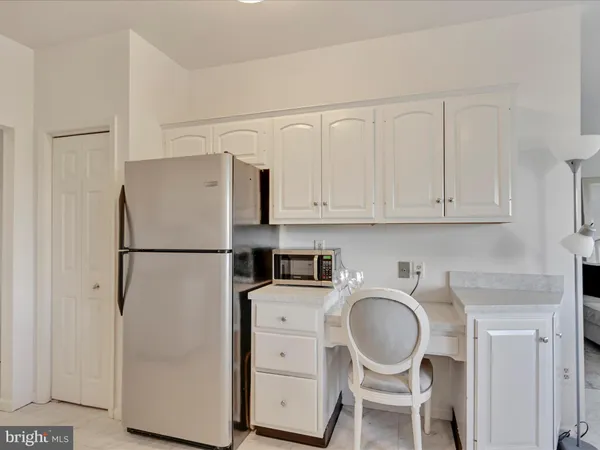 a white refrigerator freezer sitting in a kitchen
