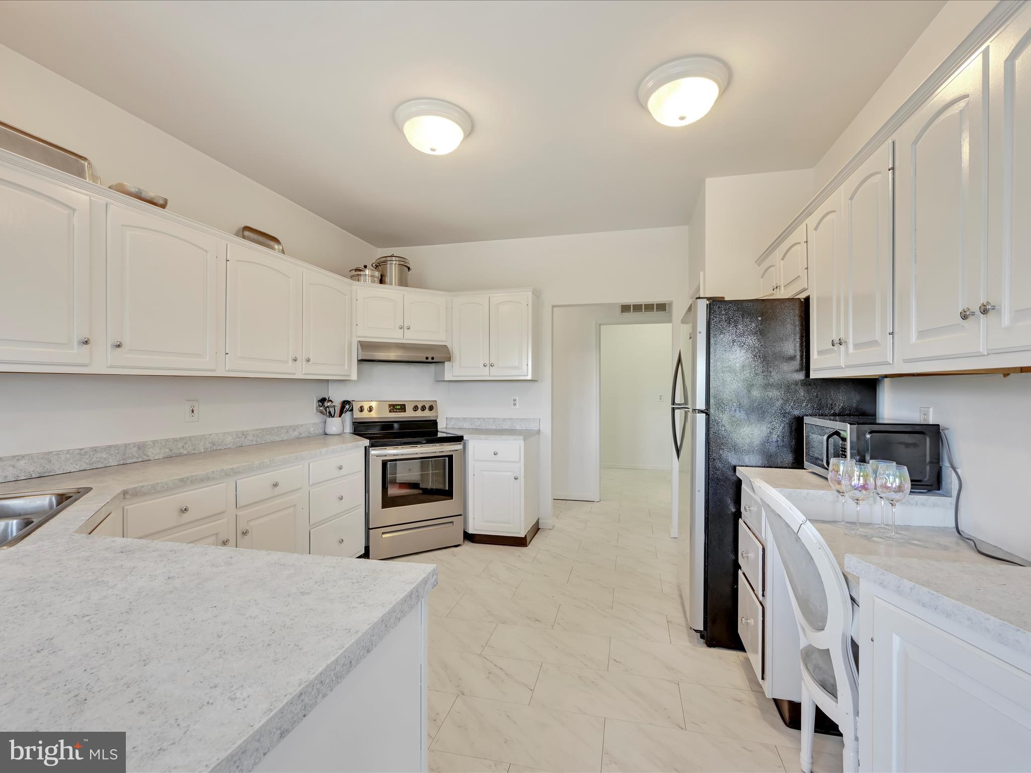 2415 Sharp Mountain Road Pottsville, PA 17901 - Photo 16 of 36 a kitchen with stainless steel appliances white cabinets and a refrigerator